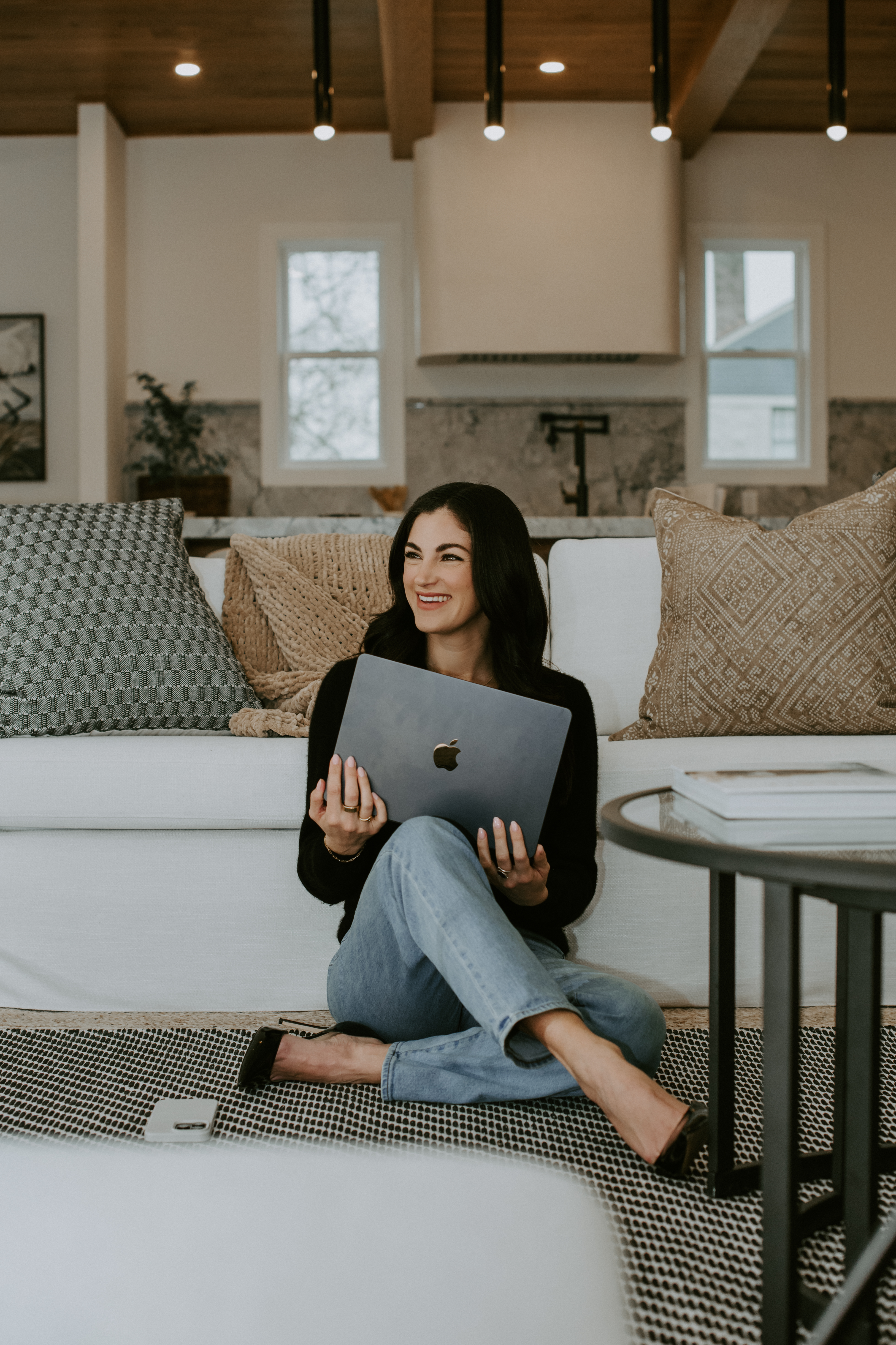 Britt holding her laptop and laughing